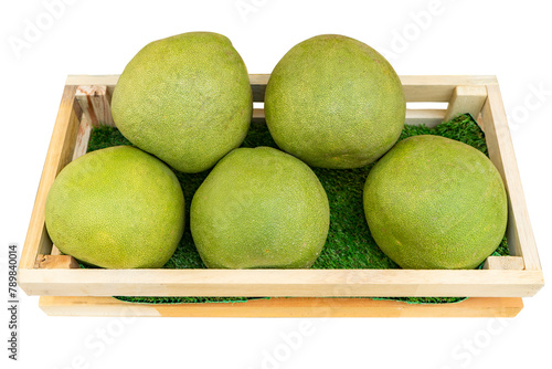 Pomelo in wooden crate isolated on white background