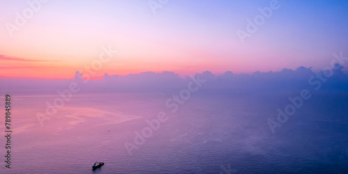 A small sailing boat in the early morning sea of Qingdao, Shandong, China photo