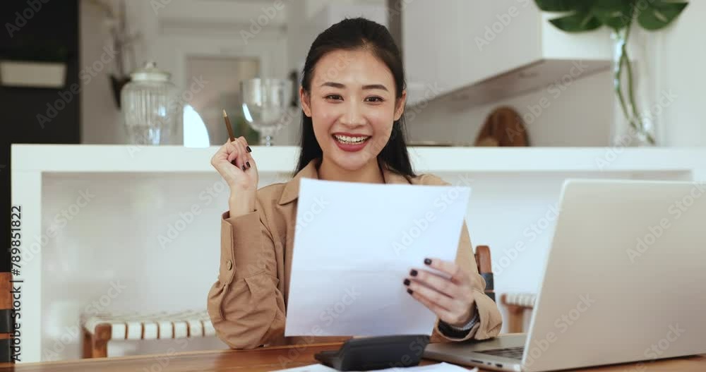 Woman sit at desk with laptop and calculator holds paper read news feel happy, get notice about successful investment returns, bank debt paid off, achievement of financial goals or increased savings Woman sit at desk with laptop and calculator holds paper read news feel happy, get notice about successful investment returns, bank debt paid off, achievement of financial goals or increased savings