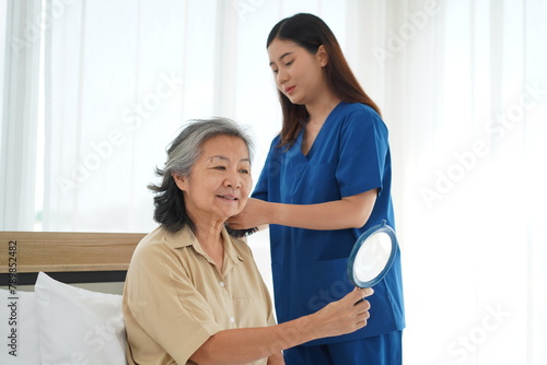 Young Caregiver Tenderly Combing Elderly Woman s Hair