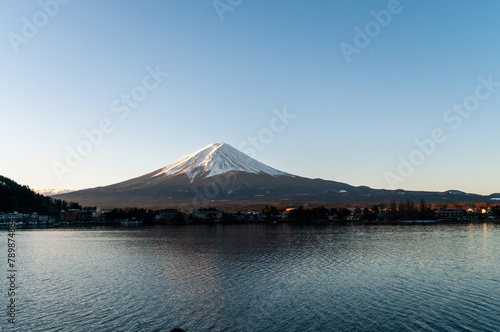 Mount Fuji on a bright winter morning, as seen from across lake Kawaguchi, and the nearby town of Kawaguchiko. © Goldilock Project