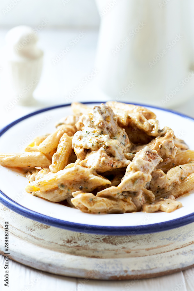 Penne Pasta baked with Meat on bright wooden Background. Close up Penne Pasta baked with Meat on bright wooden Background. Close up