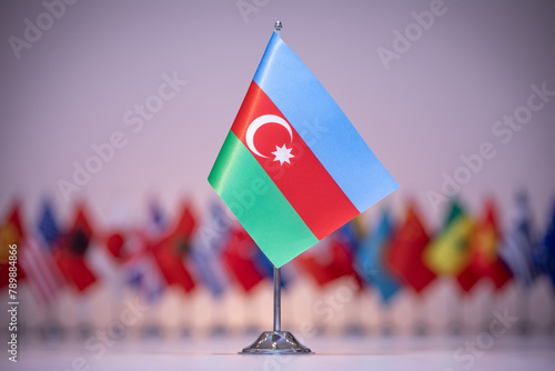 Electric blue flag of Azerbaijan among row of other flags, under sky photo