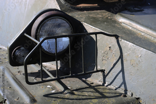Powerful spotlight close-up on old military equipment. photo