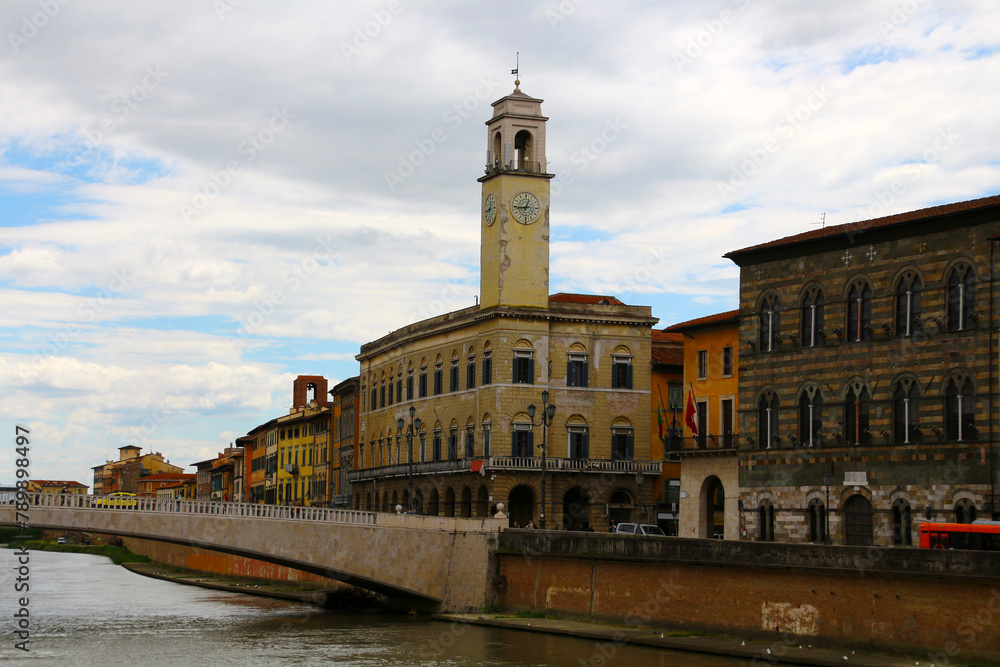 View of the ancient building Palazzo Pretorio on the banks of the Arno river in the municipality of Pisa