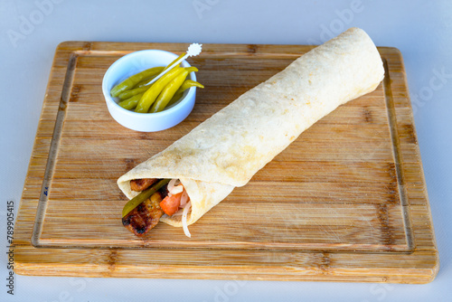 Lavash doner kebab ( zurna et tavuk doner durum )  or shawarma sliced in plate isolated.  photo