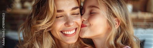 the daughter gives a kiss to her mother on the cheek mother s day concept mother and daughter love  photo