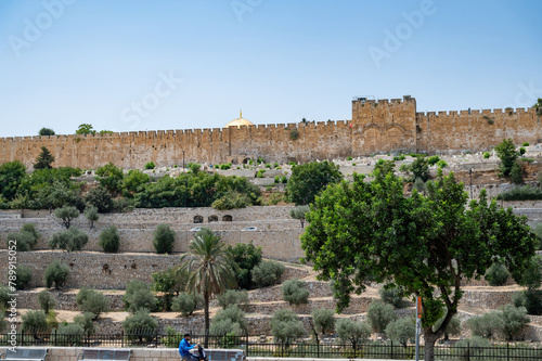 The outer walls of the old city of Jerusalem with the dome of the Al-Aqsa Mosque in the background