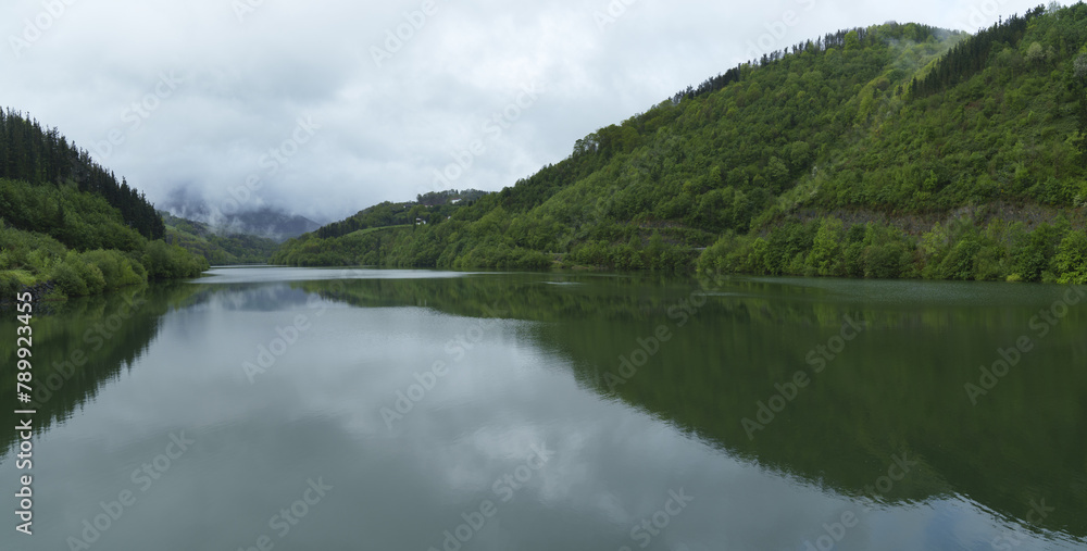 Spring in the Ibiur reservoir. The forests are reflected in the Ibiur reservoir. tolosaldea, Eusladi Spring in the Ibiur reservoir. The forests are reflected in the Ibiur reservoir. tolosaldea, Eusladi