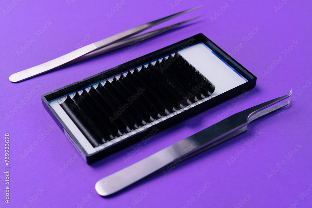 Professional eyelash extension tools on purple background Professional eyelash extension tools on purple background