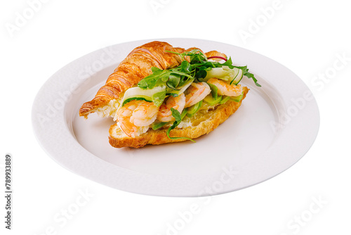 Gourmet shrimp and avocado croissant sandwich