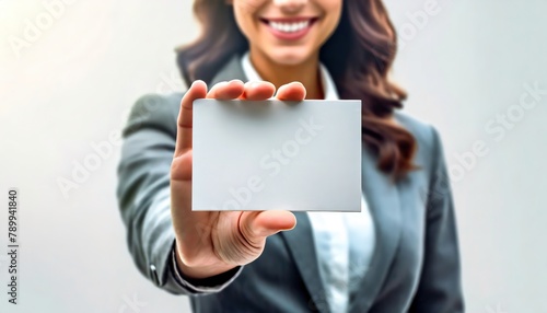 Smiling woman presenting a blank card in a business suit. Card held forefront implies an offer or invitation. Professional Presentation of a Blank. Confident businesswoman.