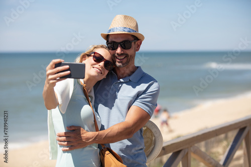 successful traveling couple in love taking a selfie on phone