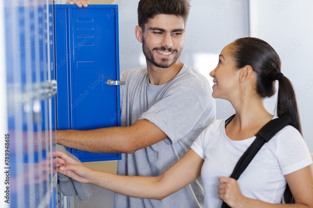 young students couple flirting in college corridor young students couple flirting in college corridor