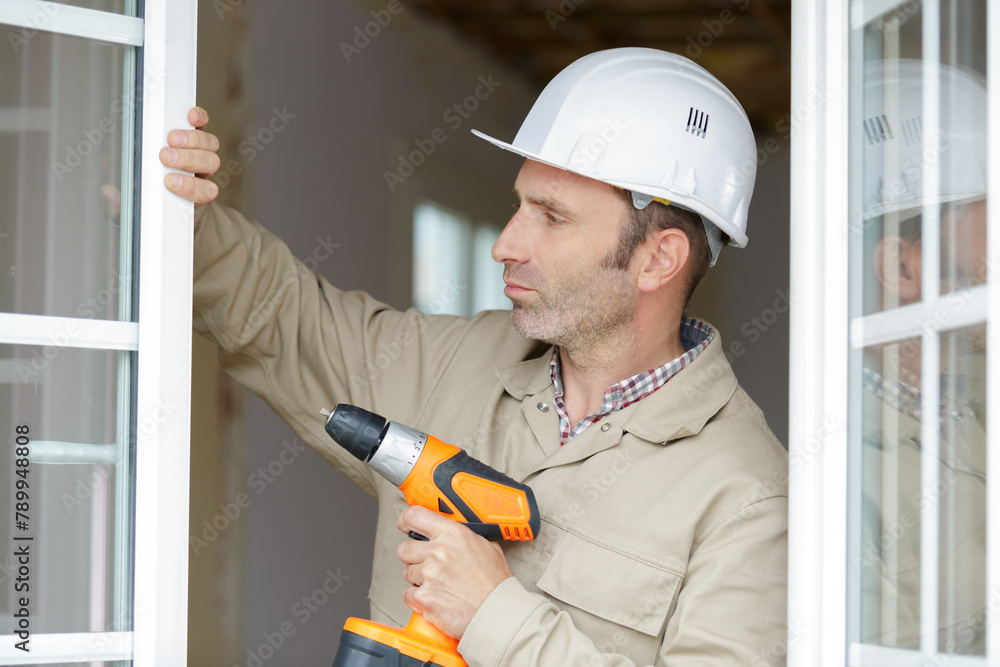 man builder installing window shades man builder installing window shades