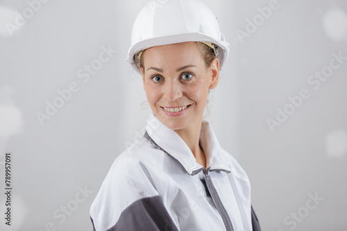 female builder looking at a window photo