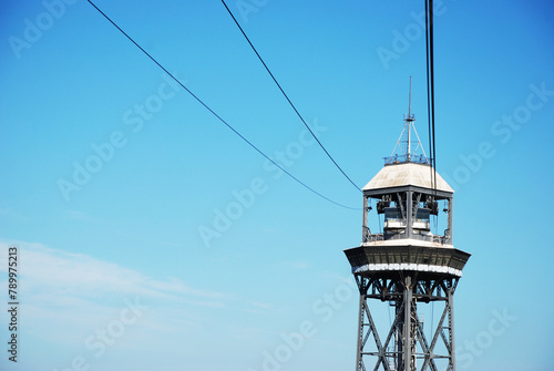 strut of the cable car line over Barcelona, Spain at daytime with a clear, blue sky
