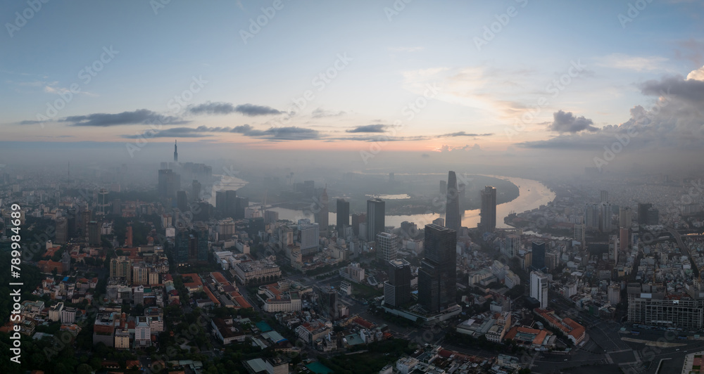 Aerial drone skyline video of Saigon cityscape at sunrise in District 1, with Sai Gon river view