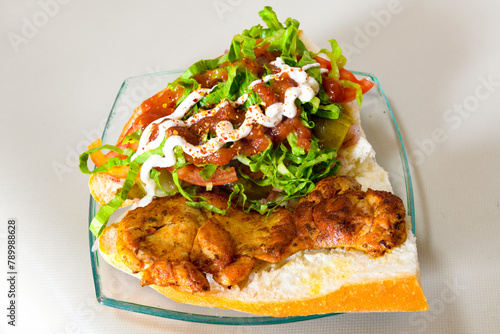 Turkish and Arabic Traditional Ramadan doner kebab with tasty tomato sauce and rice or turkish pilav in white plate on wood table background. ( Pilav ustu doner). Ekmek arasi doner, doner durum.  photo