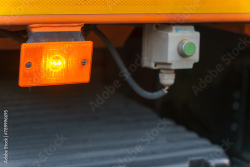 Orange reflectors on the car. Light reflectors on the hood of the truck for safe driving on the road. Car detail, close-up. Parking lights.