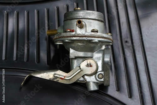 Fuel pump from an old carburetor gasoline engine of a USSR car on black background. Moskvich photo