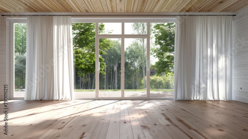 A large open room with white curtains and a window