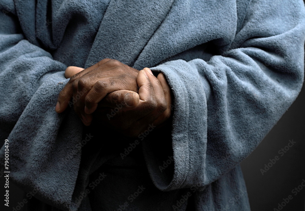 Fototapeta premium praying to god with hands together Caribbean man praying on black background with people stock photos stock photo stock image