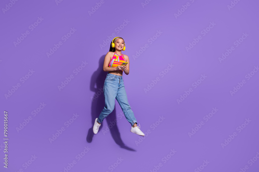 Photo of crazy cool lovely cute girl wear stylish clothes listen audio isolated on purple color background Photo of crazy cool lovely cute girl wear stylish clothes listen audio isolated on purple color background