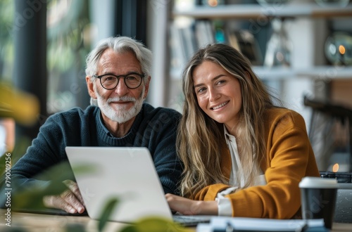 Man and Woman Looking at Laptop