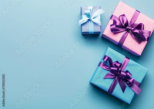 Multiple gift boxes on blue surface with text space - Giving  Gratitude  Elegance - Shopping  Corporate Gifts