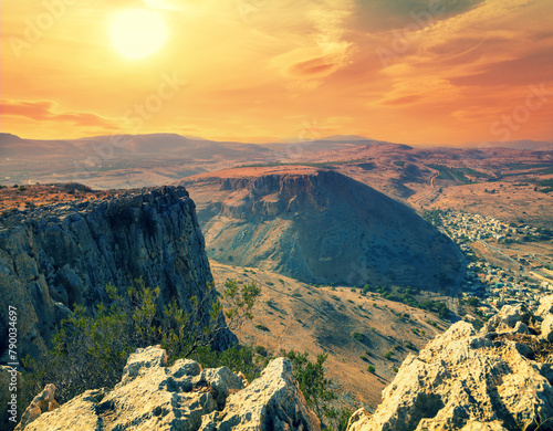 View from Mount Arbel at sunset. Arab village of Wadi Hamam in the valley. Galilee, Israel