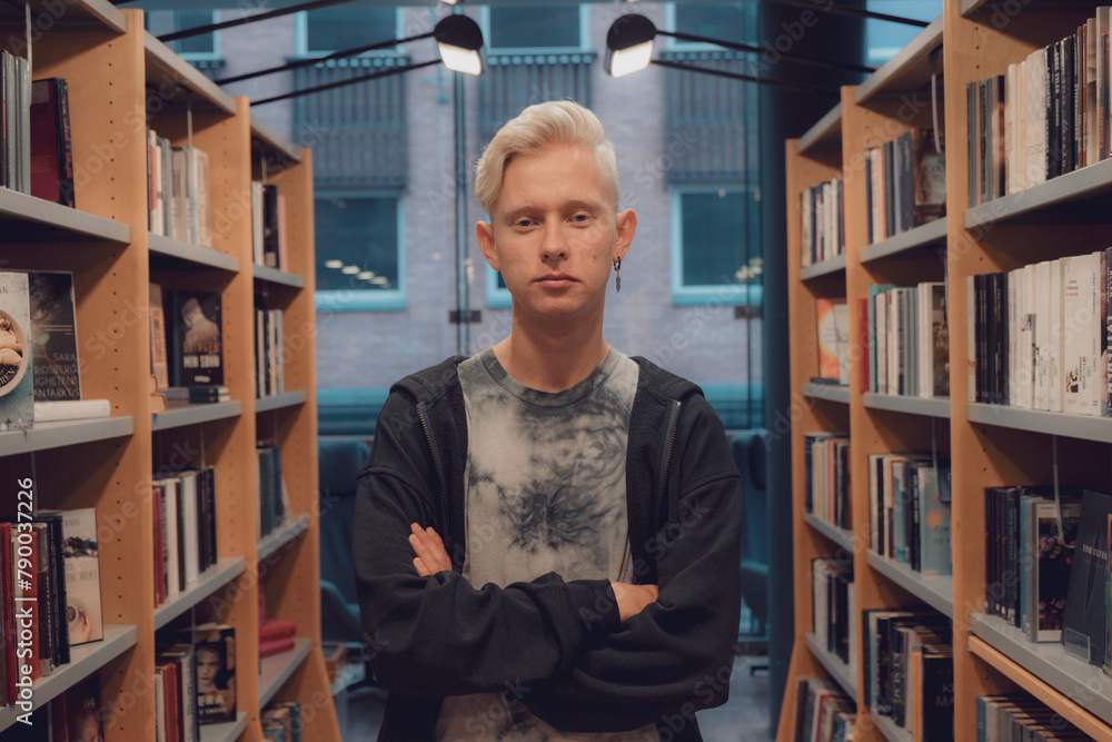 Fototapeta premium Portrait of a handsome Scandinavian student in a modern library