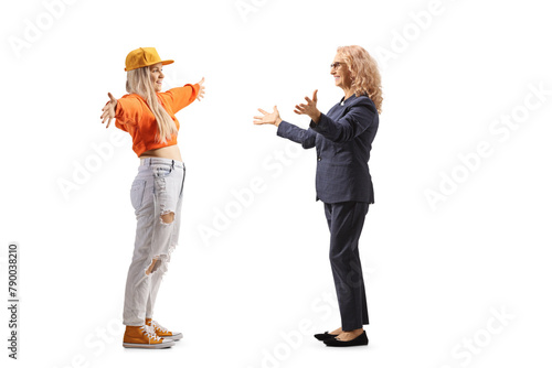 Full length profile shot of mother and daughter meeting with arms wide open
