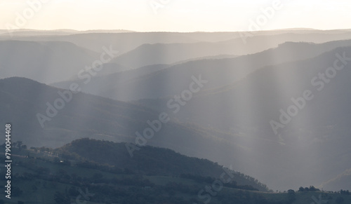 Beautiful Sunset ove the blue mountains with sun rays shining on hills, mountains, valleys, NSW, Australia 