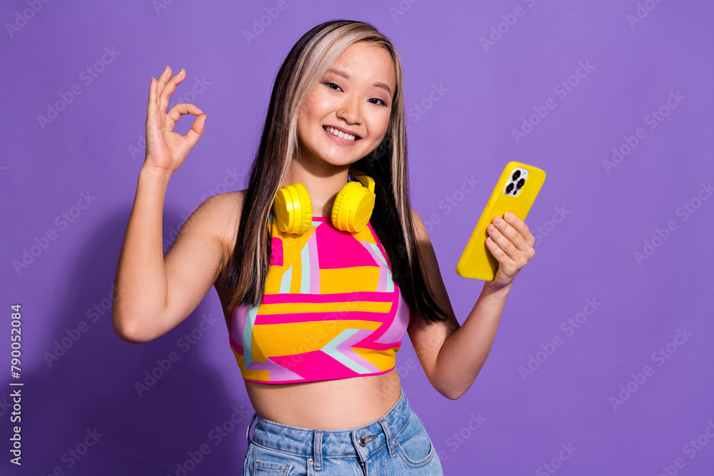Photo of charming attractive japanese girl wear trendy clothes okey sign isolated on purple color background Photo of charming attractive japanese girl wear trendy clothes okey sign isolated on purple color background