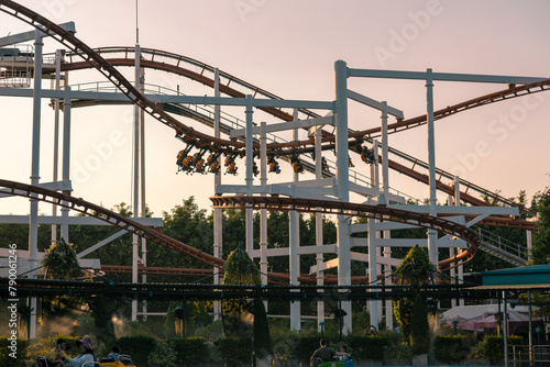 An anonymous player rides a roller coaster with the evening light as the background © chayakorn