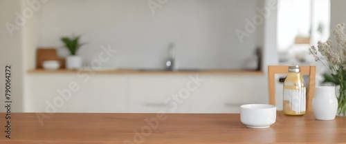 A wooden table in the foreground, with a blurred kitchen in the background
