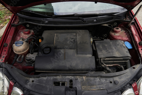 Dirty old car engine bay opened under the hood