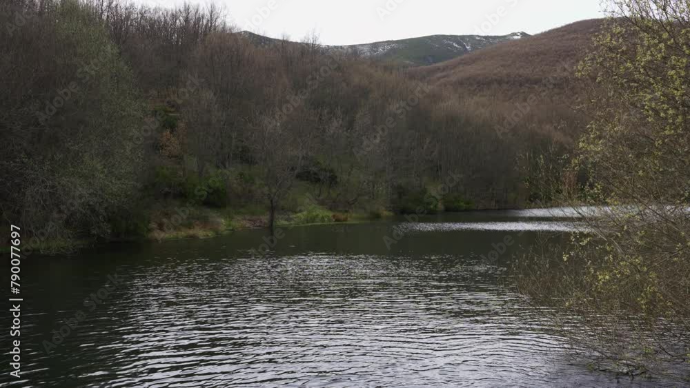 Calm stream of water in a mountain lake in the mountains of Madrid, Spain.