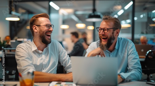 Happy businessmen laughing while working together on new project in office Use your laptop