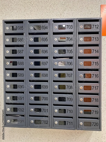 a row of mailboxes with numbers on them on a wall