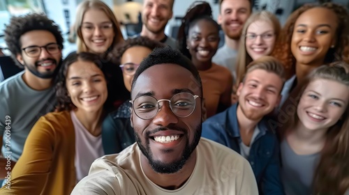 Happy diverse people celebrating teamwork together in the office, taking a group selfie portrait, embodying a joyful multicultural lifestyle concept.