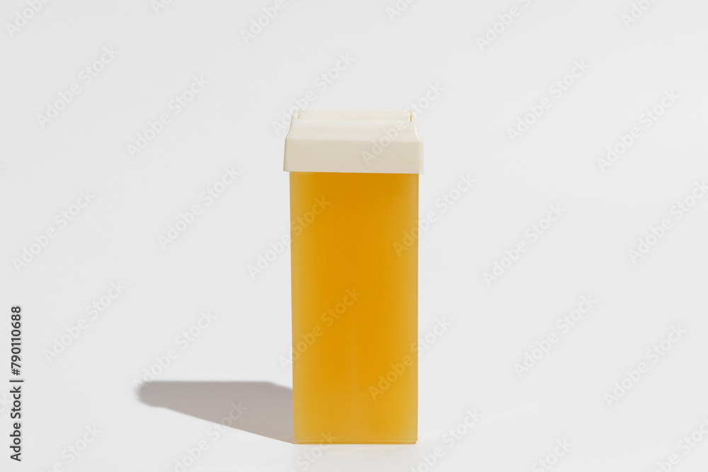 Yellow wax for depilation and body hair removal on a white isolated background. Concept of beauty, skin care. Yellow wax for depilation and body hair removal on a white isolated background. Concept of beauty, skin care.