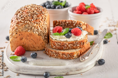Sweet and homemade whole grain bread with cheese and berries.
