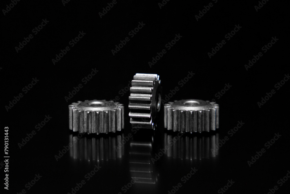 Close-up with metallic gears on a black background perfect as a decorative or ornamental image