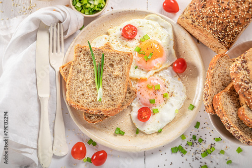 American breakfast with egg, tomato and bread. © shaiith