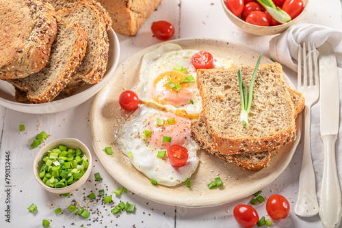 Delicious and crisp breakfast with fried eggs and bread. © shaiith