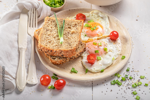 British breakfast with egg, tomato and bread. © shaiith