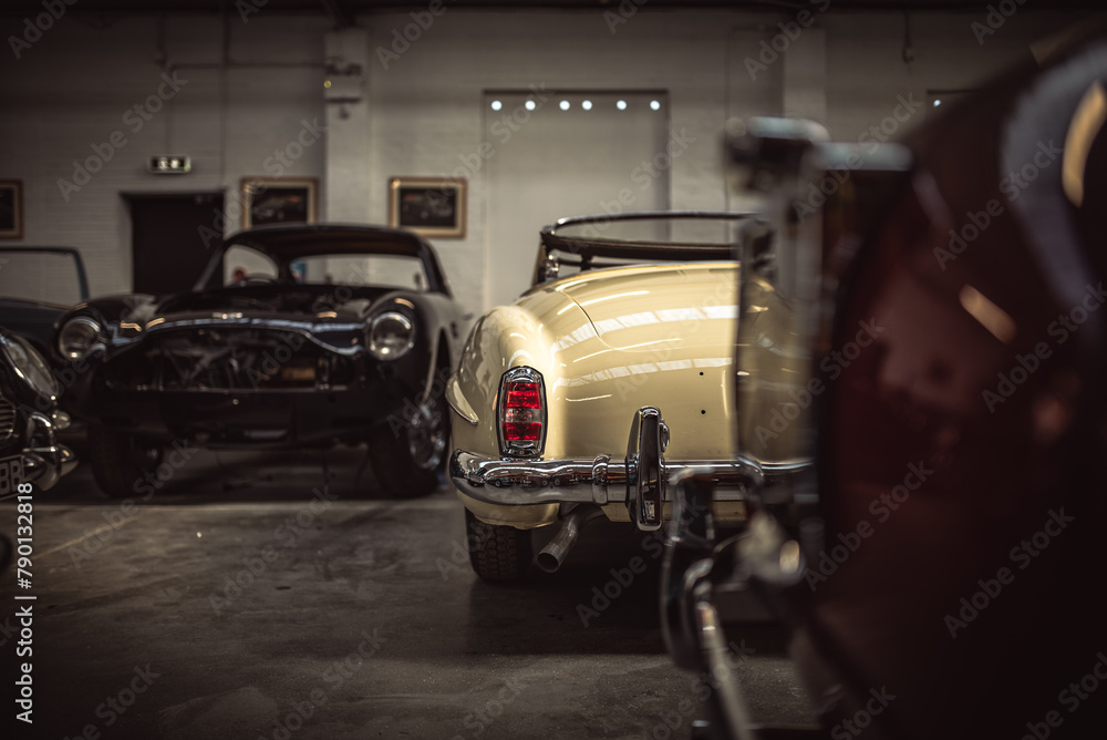 Classic cars being restored in a vintage vehicle garage workshop