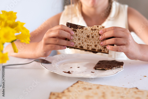 hands of girl hold matzo make sandwich with chocolate. traditional and kosher food for passover. Traditional of Jewish Holiday on Passover. 
